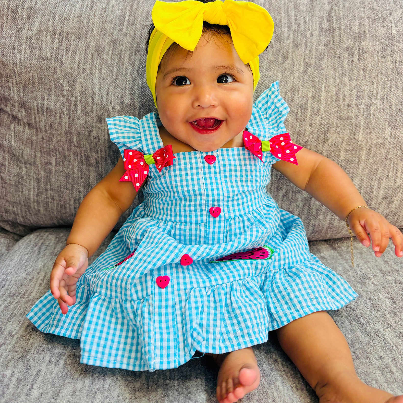 Aylany joined the competition — help win amazing prizes! baby, child, smiling, headband, yellow_bow, blue_dress, red_bows, heart_buttons, sitting, couch, indoors, happy, cute, portrait, infant, skin, foot, hand, furniture, clothing