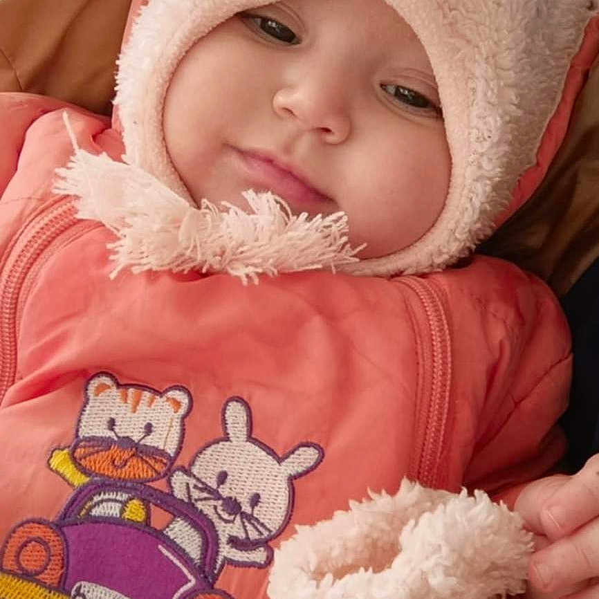 Darine participe au concours pour gagner de l'argent avec cette photo : baby, blanket, bonnet, cap, clothing, coat, face, happy, hat, head, hood, hoodie, jacket, knitwear, newborn, person, photography, portrait, smile, sweater