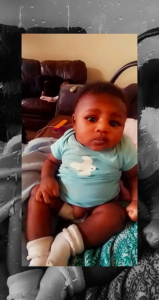 Denise is registered to the contest to win money with this photo: arm, baby, car_seat, cheek, child, cool, eye, face, hand, head, human, leg, mouth, person, product, sitting, skin, smile, thigh, toddler