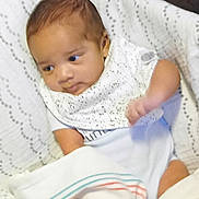 Legend joined the competition — help win amazing prizes! baby, blanket, child, clothing, comfort, cushion, cute, face, hand, indoors, infant, newborn, portrait, resting, seated, small, soft, striped, white, wrapped