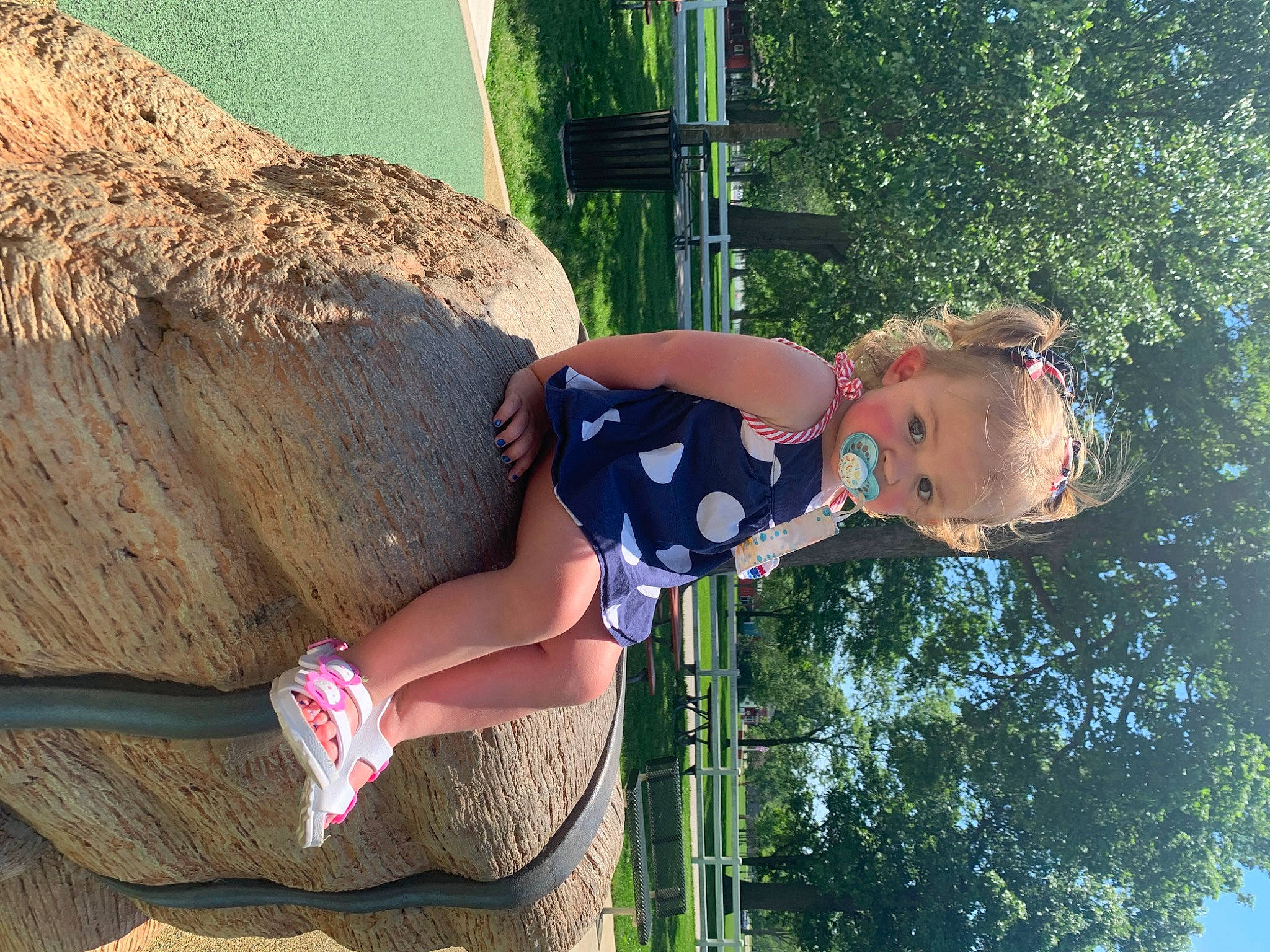 Athena is registered to the contest to win money with this photo: elbow, fun, grass, happy, human_leg, knee, landscape, leisure, people_in_nature, person, recreation, sandal, shorts, soil, summer, thigh, toddler, tree, vacation, waist