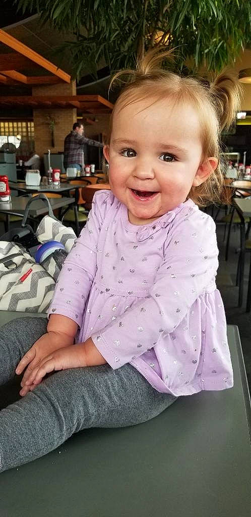 Athena is registered to the contest to win money with this photo: baby, baby_toddler_clothing, chair, cheek, child, chin, eye, flooring, fun, hair, happy, iris, joy, pattern, person, sitting, skin, sleeve, smile, t_shirt