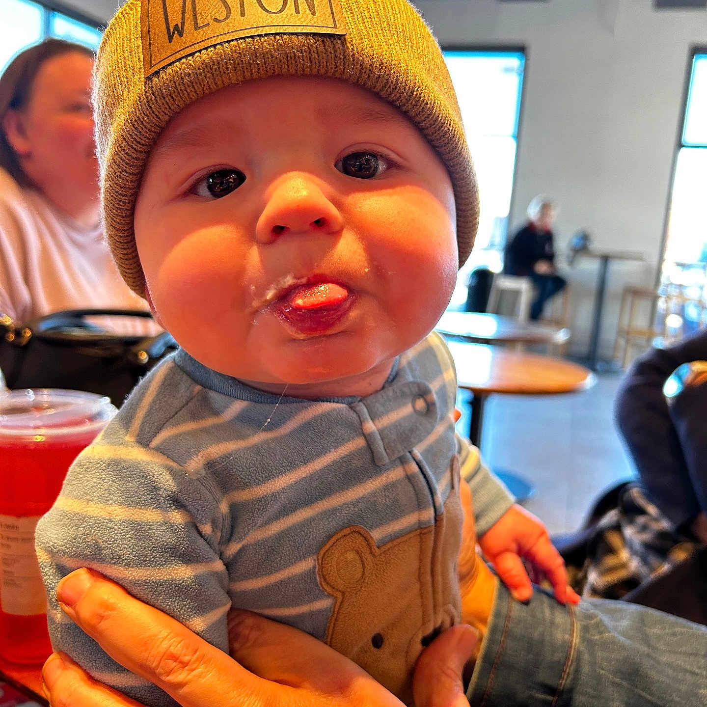 Weston joined the competition — help win amazing prizes! adult, baby, beanie, bodypart, cap, clothing, couch, face, finger, hand, hat, head, indoors, jeans, male, man, pants, person, photography, portrait