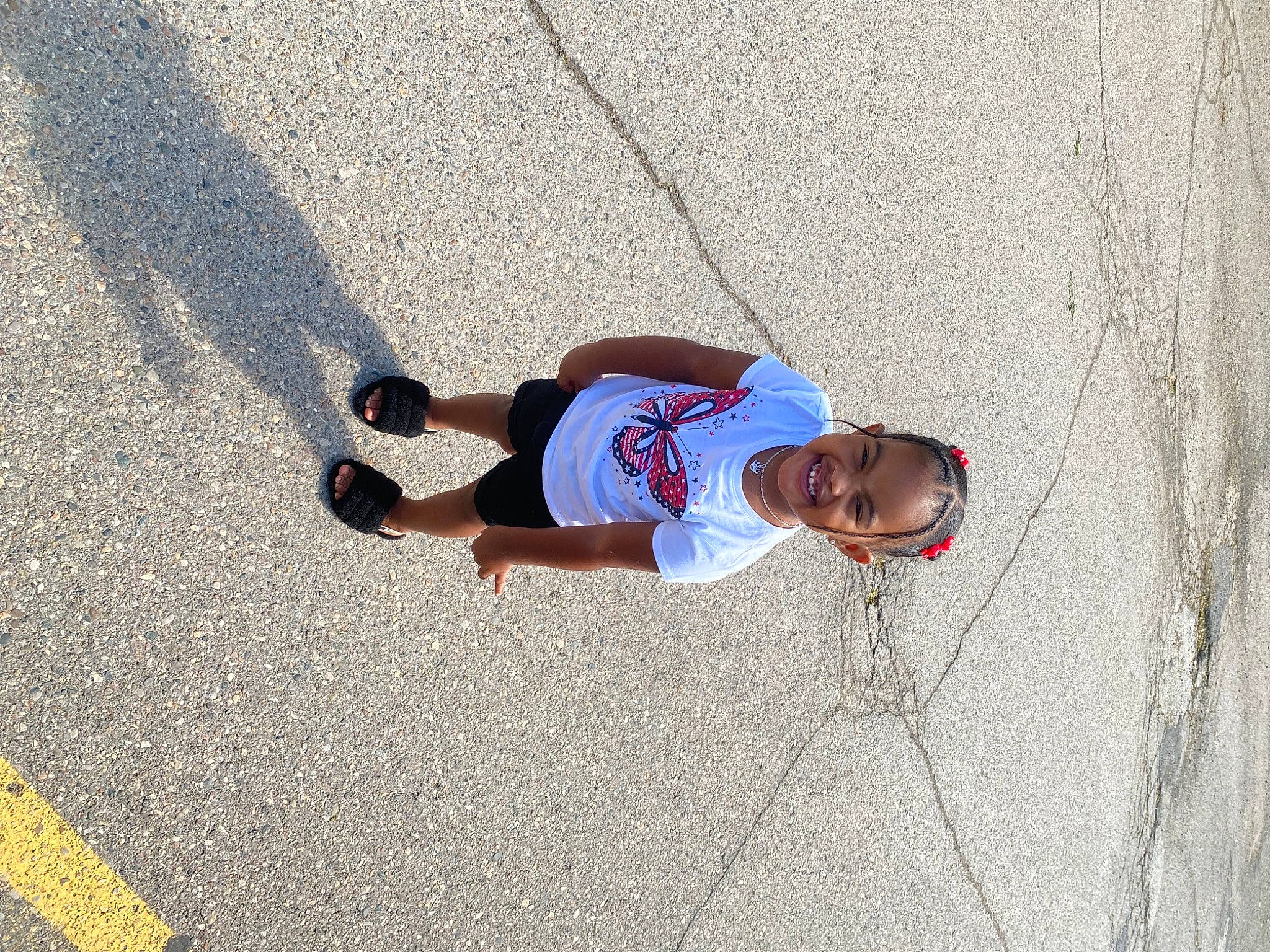 Kamariah is registered to the contest to win money with this photo: asphalt, concrete, electric_blue, hat, human_leg, joy, knee, leisure, pedestrian, person, public_space, recreation, road, road_surface, shadow, shorts, sidewalk, street, sunglasses, t_shirt