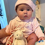 Sayloir Bleu joined the competition — help win amazing prizes! baby, child, infant, pink_clothing, hat, stuffed_animal, bunny_toy, hand, indoor, cute, soft_toy, person, sitting, face, chubby_cheeks, toy, clothing, expressionless, skin, holding