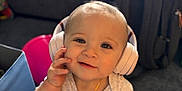 Audis joined the competition — help win amazing prizes! toddler, child, headphones, smile, indoors, face, person, clothing, shirt, hand, backpack, floor, carpet, baby, cute, expression, young_child, accessory, listening, technology