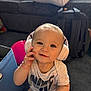toddler, child, headphones, smile, indoors, face, person, clothing, shirt, hand, backpack, floor, carpet, baby, cute, expression, young_child, accessory, listening, technology