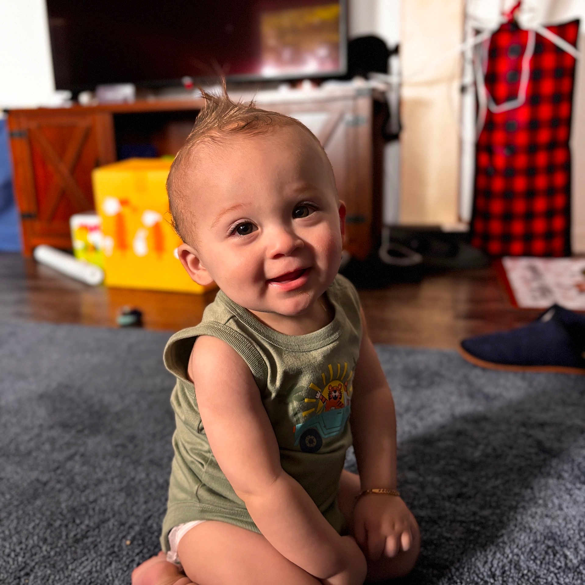 Audis joined the competition — help win amazing prizes! baby, bracelet, cabinet, carpet, child, clothing, cute, expression, face, floor, furniture, hairstyle, happy, indoor, living_room, person, plaid, sitting, smiling, toy_box