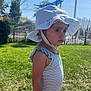 toddler, child, outdoor, grass, sunhat, striped_clothing, summer, daylight, portrait, side_view, young_child, curious, solemn, greenery, nature, playground, barefoot, necklace, person, sunshine
