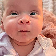 Leilani joined the competition — help win amazing prizes! baby, child, close_up, cozy, curious, cute, expression, face, head, infant, newborn, person, portrait, skin, soft_light, texture, warm, white_clothing, wide_eyes, young