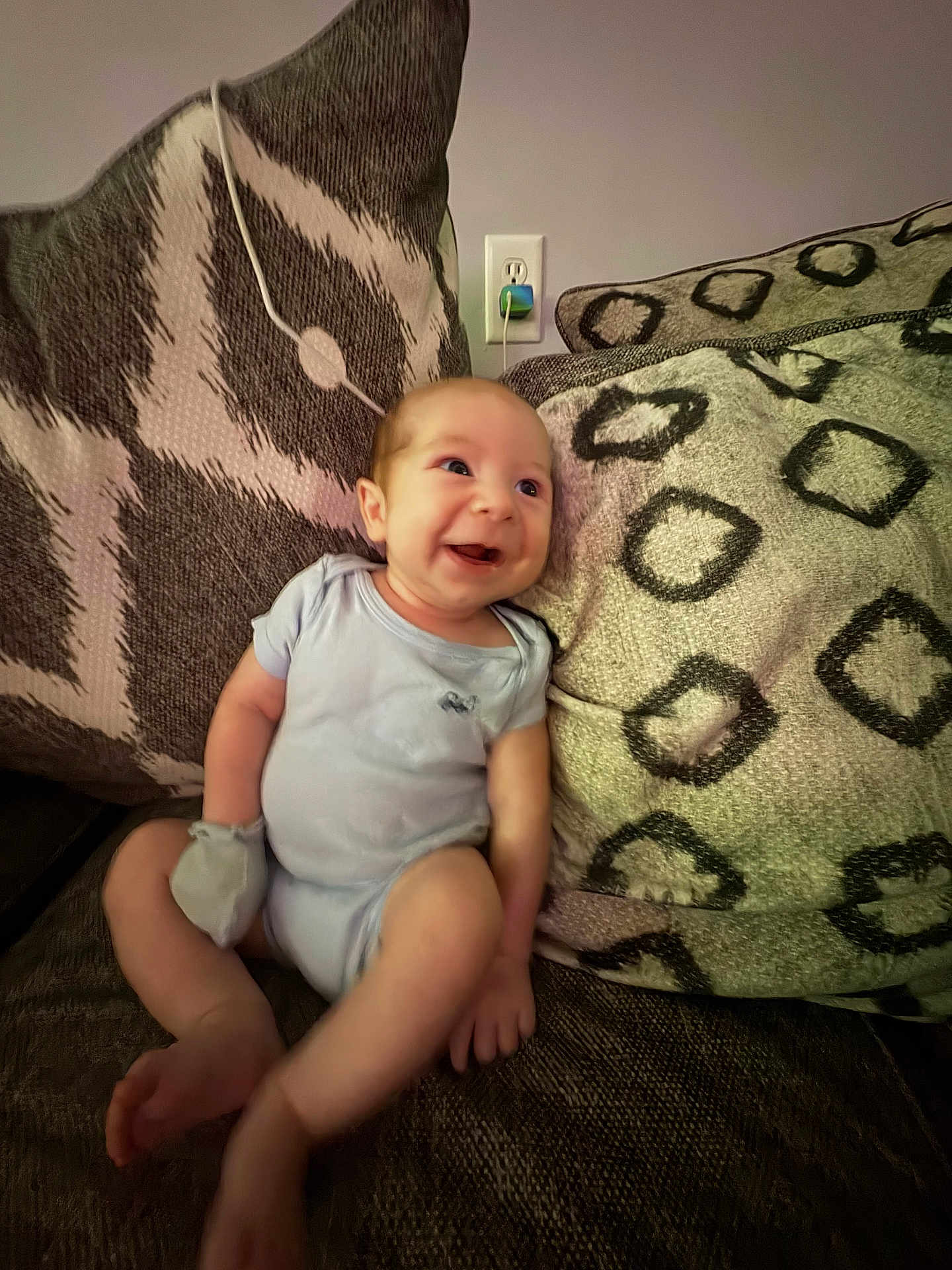 Jasiah joined the competition — help win amazing prizes! baby, smiling, couch, pillow, infant, indoor, onesie, face, happy, person, furniture, home, sitting, pattern, wall, outlet, cozy, cute, child, relax