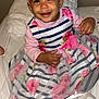 Maianna participe au concours pour gagner de l'argent avec cette photo : toddler, child, smiling, headband, flower, dress, striped, pink, floral, sitting, bed, white, sock, happy, cute, person, indoors, clothing, portrait, baby