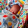 Brandon is registered to the contest to win money with this photo: baby, bed, blanket, couch, cradle, crib, cushion, face, furniture, head, homedecor, infantbed, newborn, pattern, person, photography, portrait, quilt, sleeping, towel