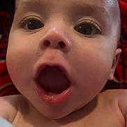 Kai joined the competition — help win amazing prizes! baby, child, face, mouth_open, close_up, expression, curious, skin, head, eyes, infant, portrait, indoors, person, human, newborn, cheeks, background, red, black