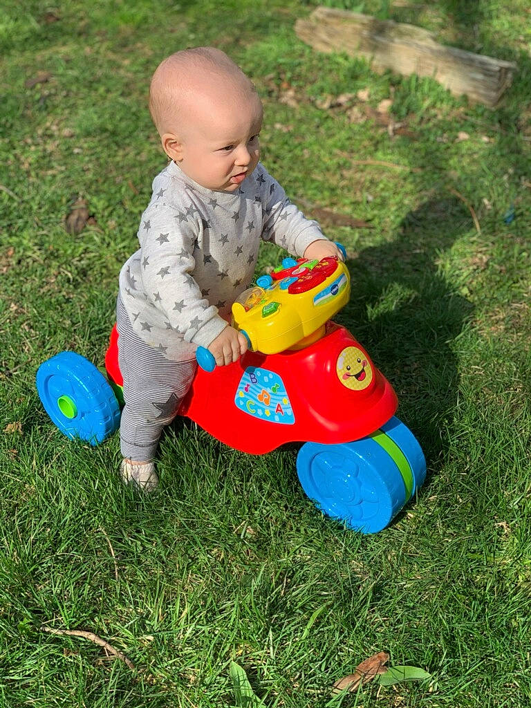Josh is registered to the contest to win money with this photo: baby, baby_products, baby_toddler_clothing, baby_toys, child, flooring, fun, garden, grass, happy, lawn, leisure, people_in_nature, person, play, recreation, sitting, smile, toddler, toy