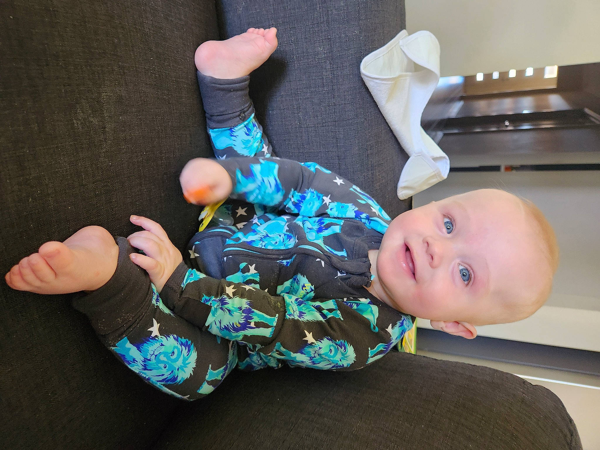 Dakota is registered to the contest to win money with this photo: baby, baby_toddler_clothing, child, comfort, cool, finger, foot, fun, gas_stove, gesture, hand, human_body, joint, leg, person, product, sleeve, smile, sock, thigh