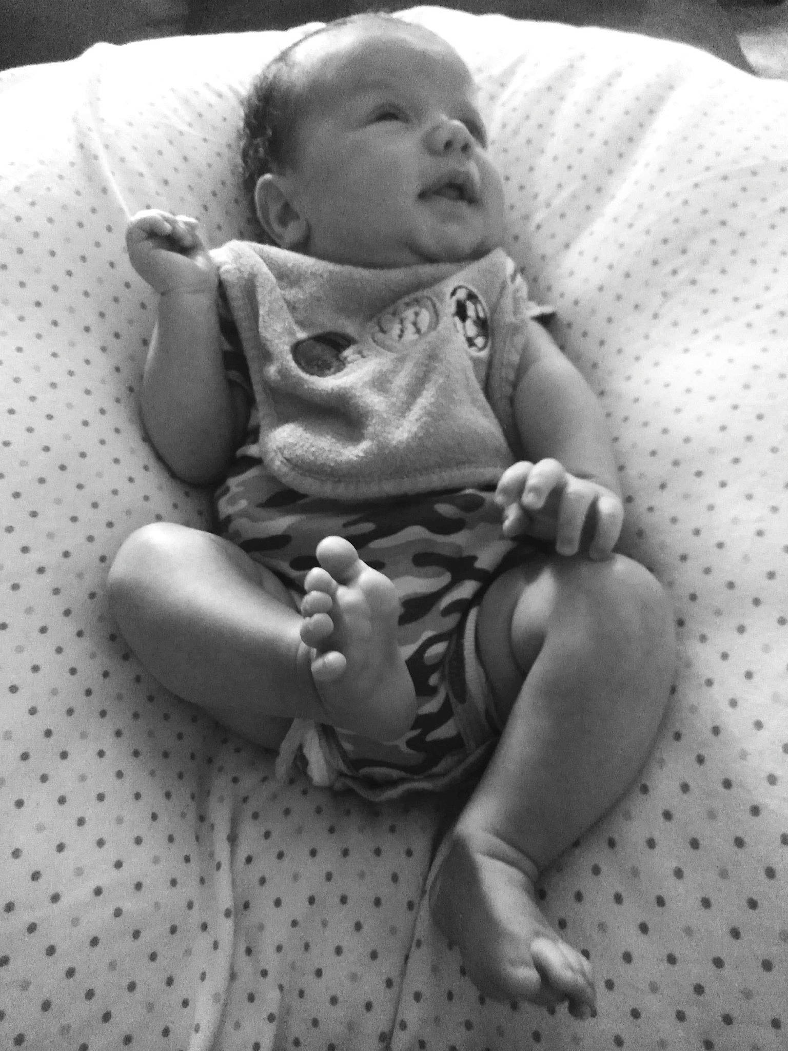 Maverick is registered to the contest to win money with this photo: baby, birth, black_and_white, cheek, child, facial_expression, finger, leg, monochrome, person, photography, sitting, skin, smile, style, toddler