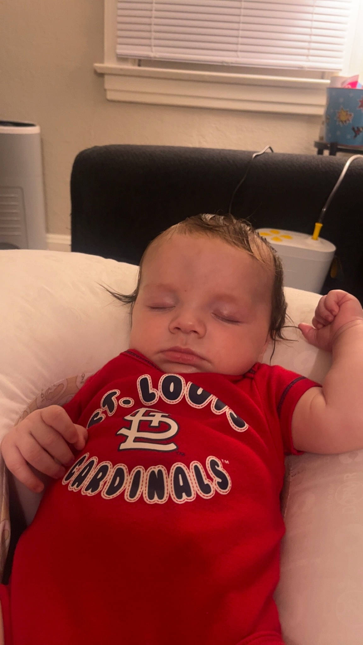 Malakai is registered to the contest to win money with this photo: baby, baby_toddler_clothing, cheek, chin, comfort, eye, eyebrow, fun, happy, iris, lip, mouth, neck, nose, person, room, shoulder, skin, sleeve, t_shirt