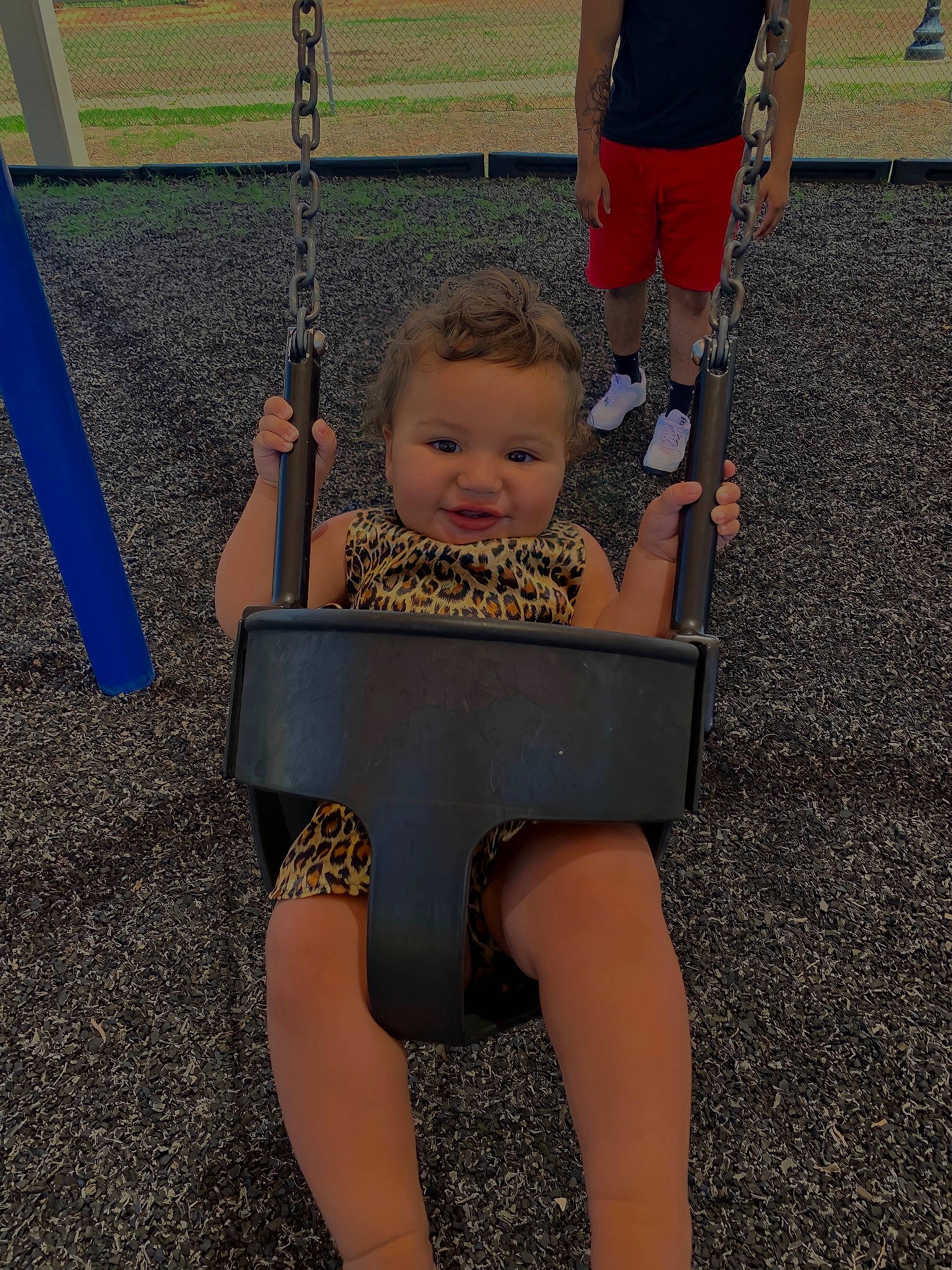 Alaiyah is registered to the contest to win money with this photo: arm, baby, baby_toddler_clothing, barefoot, child, foot, fun, grass, human_leg, knee, lap, leg, leisure, person, playground, sandal, swing, thigh, toddler, white