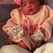 Amira joined the competition — help win amazing prizes! baby, sleeping, pink_bow, mittens, blanket, sweater, infant, cozy, cute, child, portrait, rest, soft, warm, indoor, peaceful, clothing, headband, newborn, face