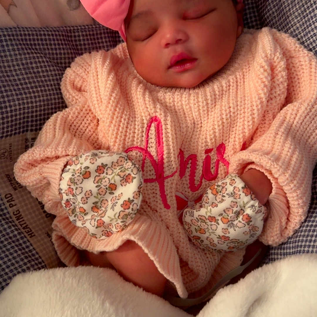 Amira joined the competition — help win amazing prizes! baby, sleeping, pink_bow, mittens, blanket, sweater, infant, cozy, cute, child, portrait, rest, soft, warm, indoor, peaceful, clothing, headband, newborn, face