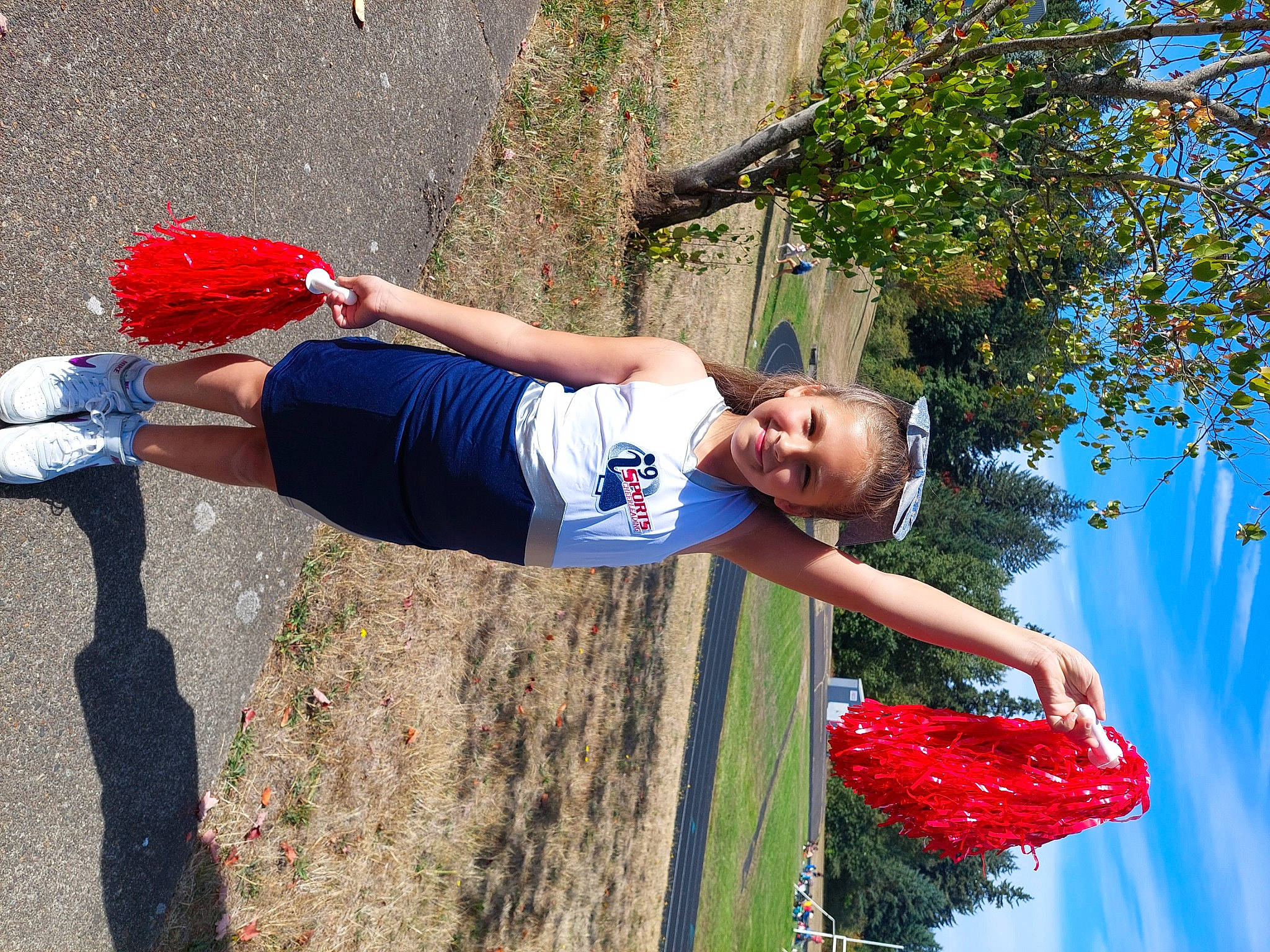 Mya is registered to the contest to win money with this photo: child, electric_blue, fun, grass, happy, human_leg, joy, leisure, people_in_nature, person, pole, recreation, sky, smile, sports_uniform, sportswear, t_shirt, thigh, toddler, tree