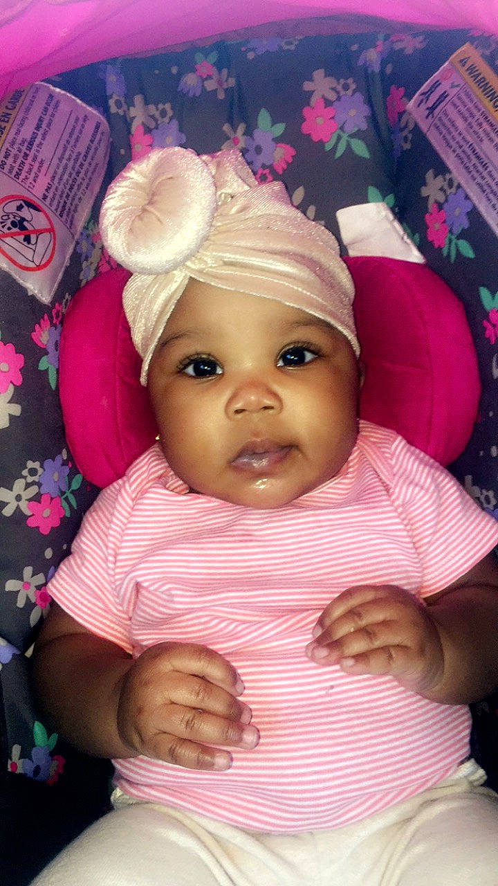 Emoni Griffith is registered to the contest to win money with this photo: baby, baby_products, cheek, child, eye, face, hair_accessory, head, headgear, iris, lip, person, pink, product, skin, smile, toddler
