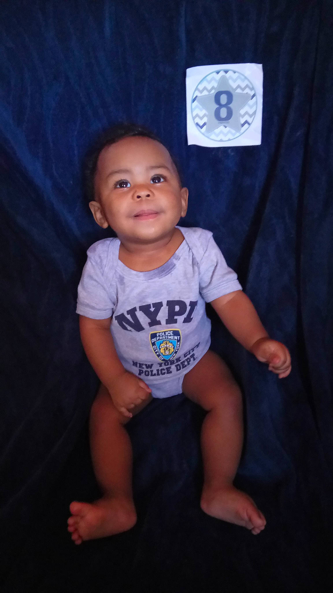 Jeremiah is registered to the contest to win money with this photo: baby, blue, cheek, child, face, family, head, person, sitting, smile, standing, t_shirt, toddler