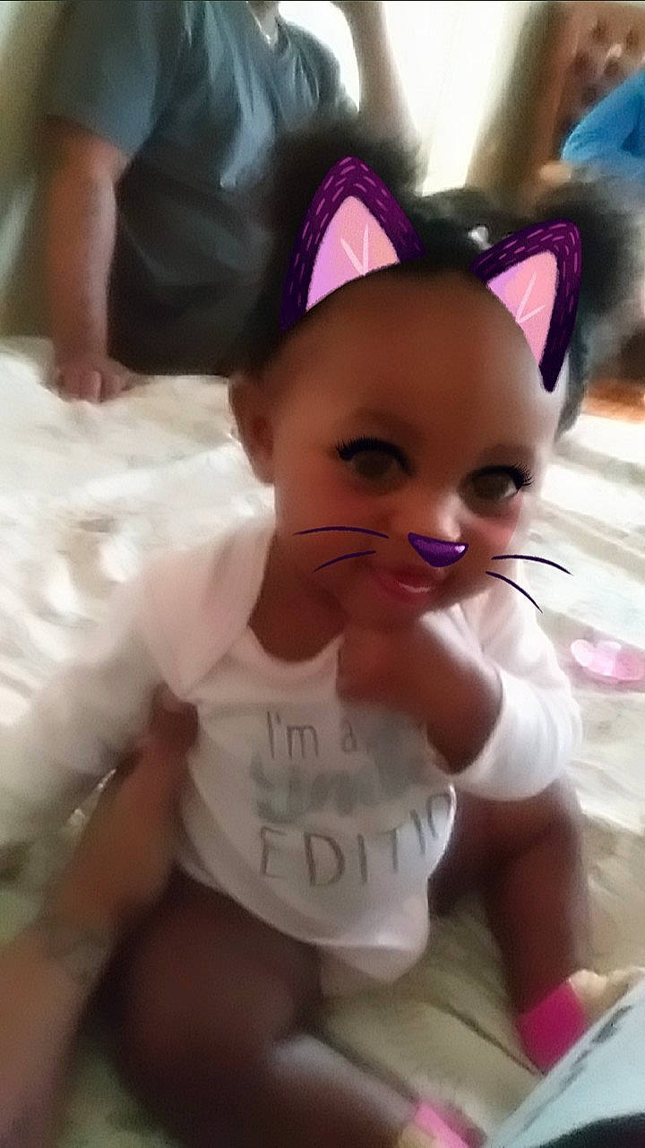 Harlem is registered to the contest to win money with this photo: baby, cheek, child, ear, eye, eyebrow, face, forehead, hair, hair_accessory, head, headgear, lip, mouth, nose, person, pink, skin, smile, toddler