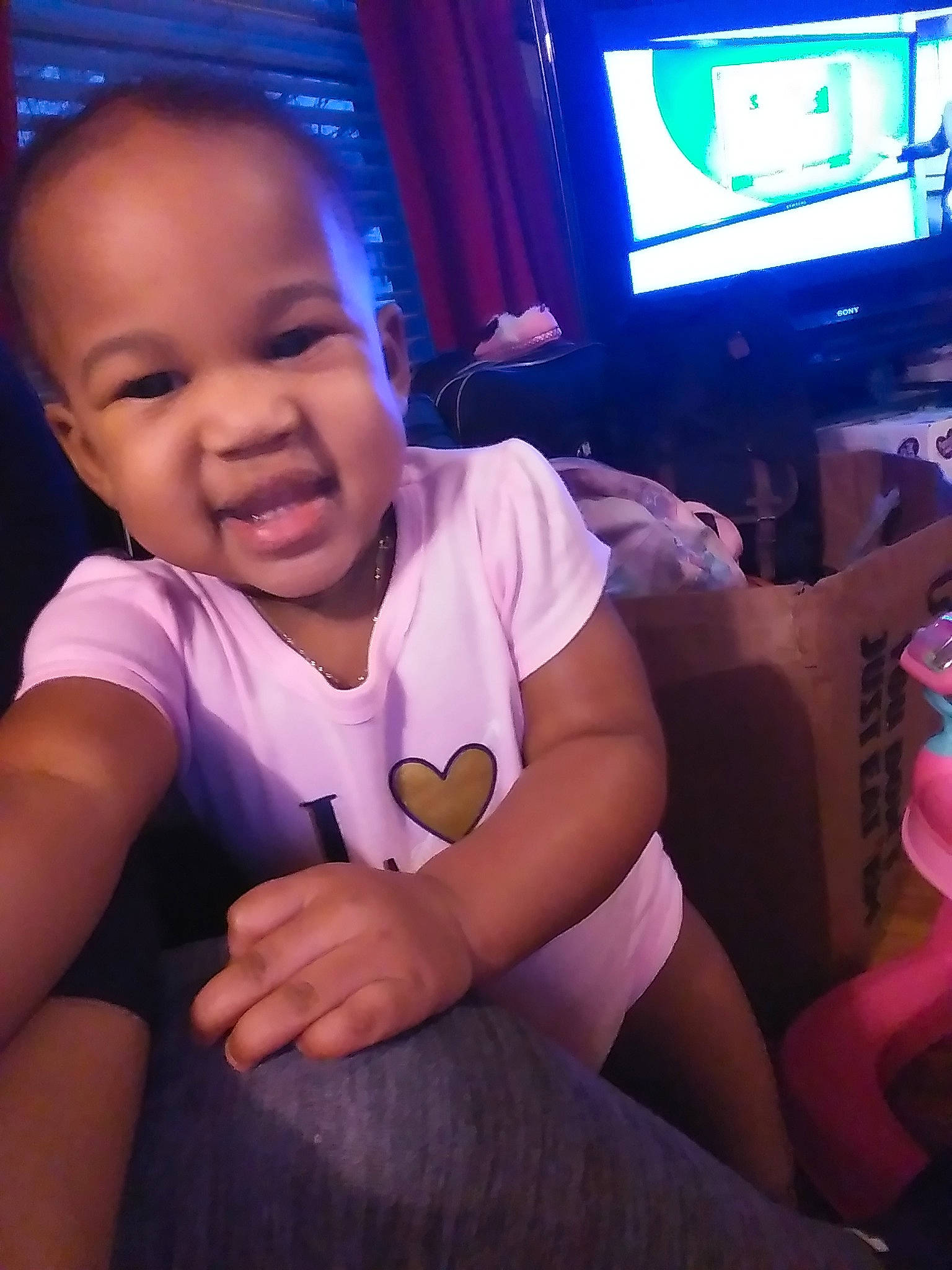 Malani joined the competition — help win amazing prizes! baby, cheek, child, cool, electronic_device, finger, fun, gadget, hand, lap, leg, mouth, person, play, sitting, technology, thigh, thumb, toddler