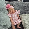 baby, girl, smiling, pink_headband, striped_dress, couch, pillows, cozy, indoor, cute, infant, child, happy, portrait, relaxing, soft_texture, home, seated, comfortable, adorable