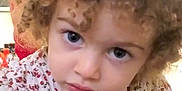 Alina is registered to the contest to win money with this photo: child, toddler, curly_hair, blue_eyes, floral_shirt, portrait, face, looking, indoor, cute, young, person, closeup, expression, innocent, curious, clothing, head, skin, baby