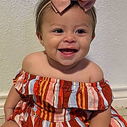 Scarlett joined the competition — help win amazing prizes! baby, child, smiling, bow, dress, striped_clothing, sitting, floor, tile, happy, face, headband, cute, indoors, infant, person, young_child, skin, cheerful, portrait