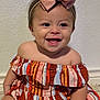 baby, child, smiling, bow, dress, striped_clothing, sitting, floor, tile, happy, face, headband, cute, indoors, infant, person, young_child, skin, cheerful, portrait