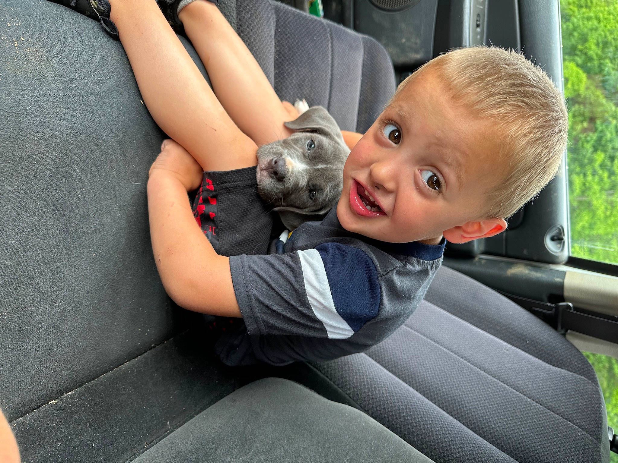 Henry joined the competition — help win amazing prizes! arm, automotive_design, automotive_exterior, automotive_tire, baby_toddler_clothing, car, car_seat, comfort, finger, grass, knee, leg, motor_vehicle, person, plant, smile, thigh, thumb, toddler, vehicle_door