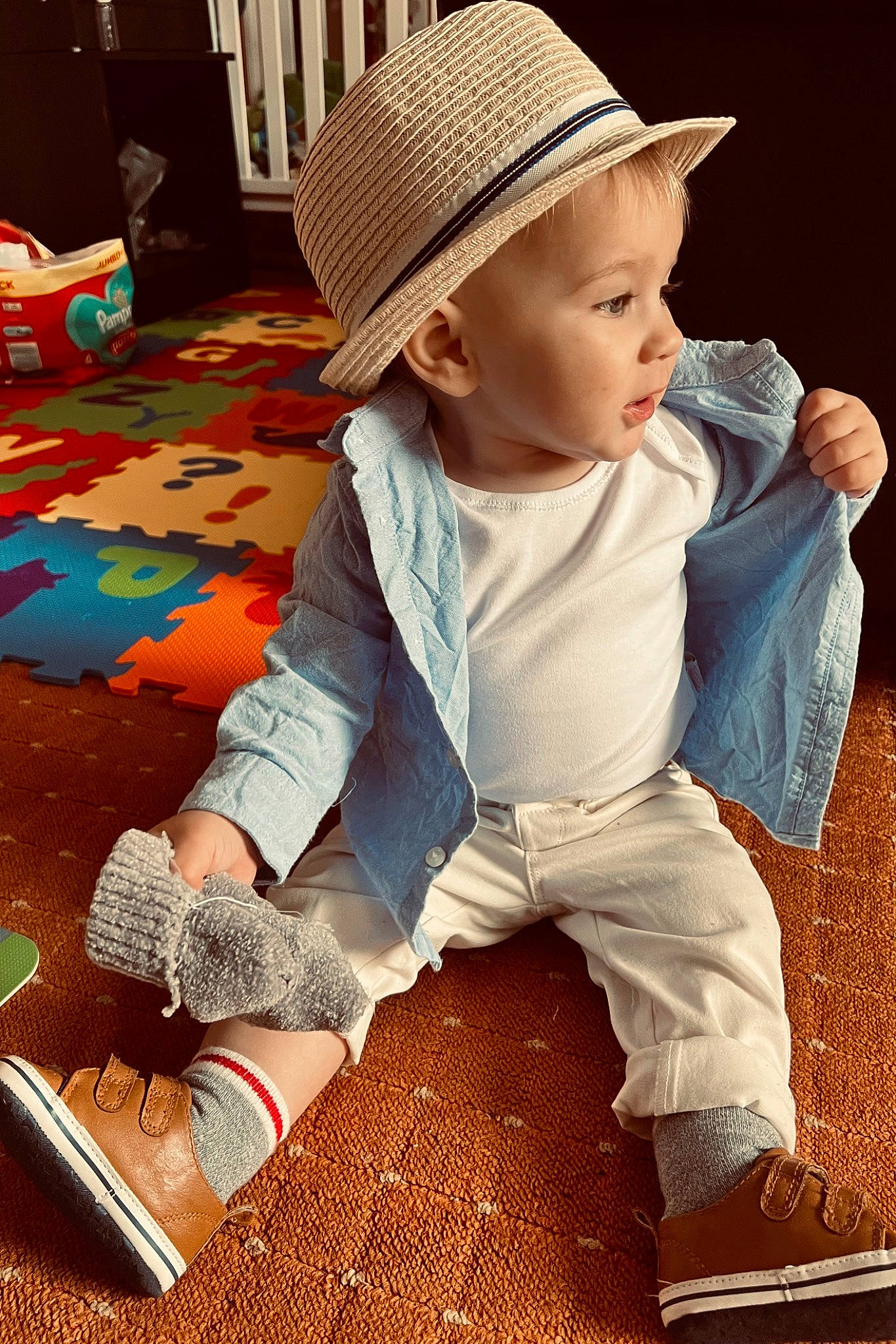 Erick is registered to the contest to win money with this photo: baby, baby_toddler_clothing, cap, carmine, child, comfort, cool, fashion_accessory, flooring, fun, happy, hat, human_leg, pattern, person, play, shoe, sitting, sleeve, sun_hat
