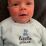 George joined the competition — help win amazing prizes! baby, infant, sweater, blue, face, eyes, mouth, person, child, cute, portrait, knitwear, clothing, childrenswear, closeup, skin, newborn, head, expression, indoors
