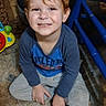 Ezekiel is registered to the contest to win money with this photo: child, toddler, smiling, red_hair, portrait, sitting, indoor, playroom, toy, blue_toy, play_structure, long_sleeves, gray_pants, socks, tile_floor, rug, home, happy, face, photography