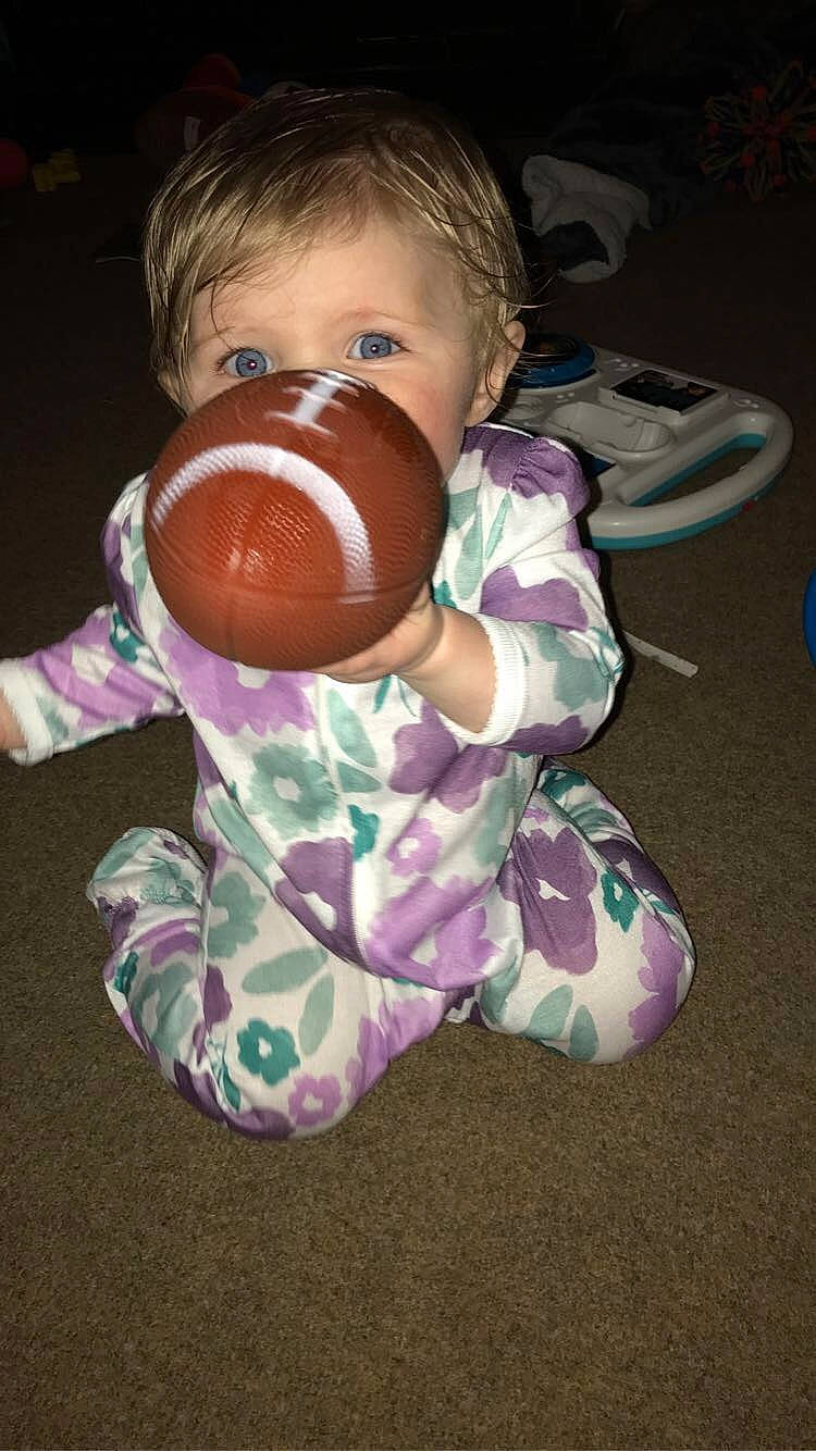 Aurora is registered to the contest to win money with this photo: baby, baby_products, baby_toddler_clothing, baby_toys, cheek, child, comfort, drinking, drinkware, flooring, fun, nail, nose, person, personal_protective_equipment, play, sitting, sleeve, thumb, toddler