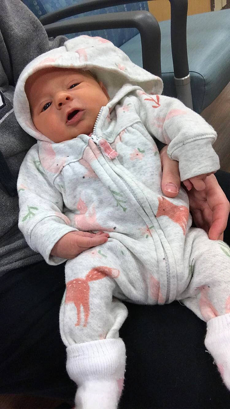 Layla is registered to the contest to win money with this photo: baby, baby_products, baby_toddler_clothing, carmine, cheek, child, comfort, fur, hat, headwear, linens, person, pink, sitting, skin, sleeve, thumb, toddler, white