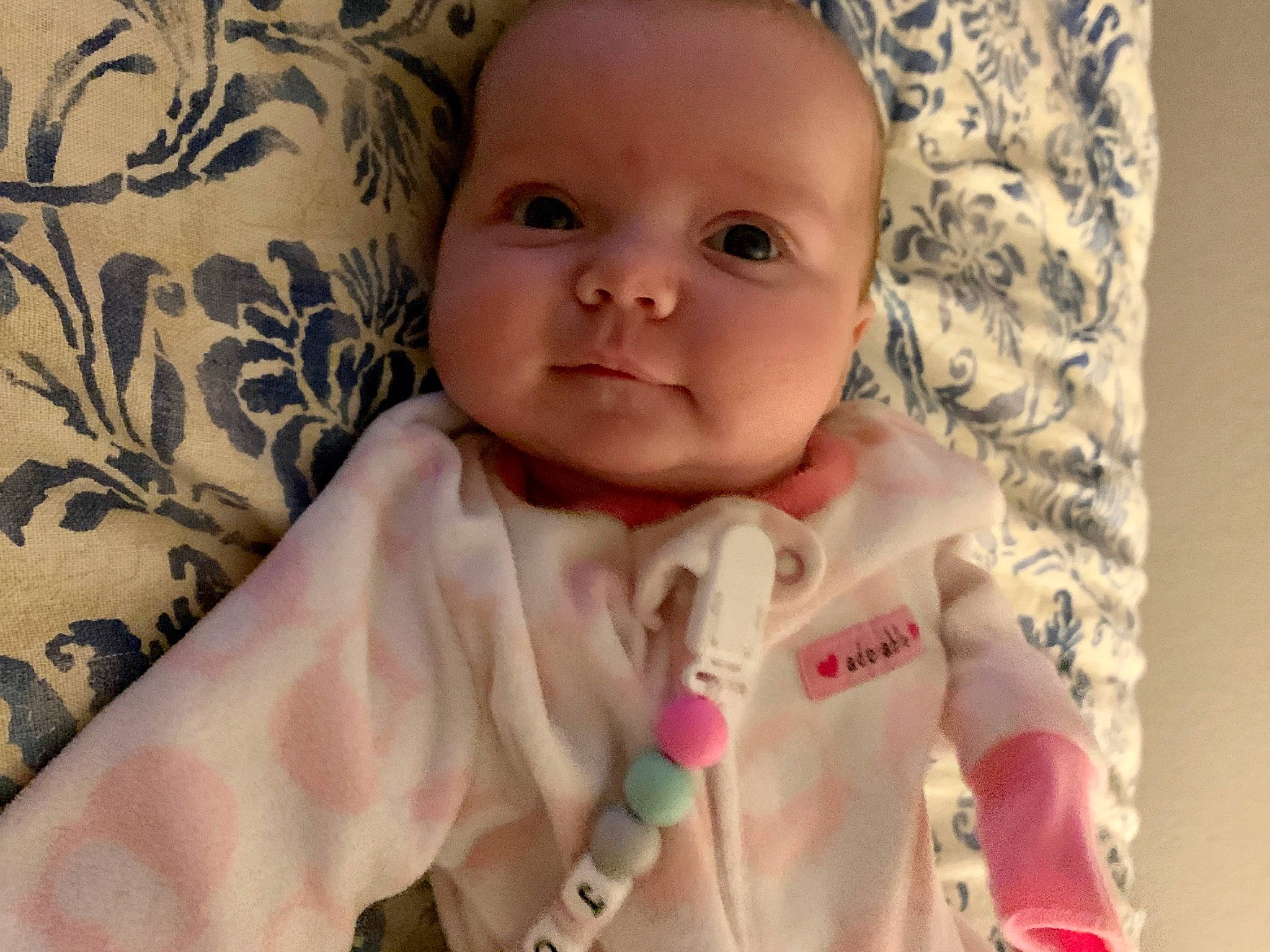 Joslyn is registered to the contest to win money with this photo: baby, cheek, child, eye, face, finger, forehead, hand, head, iris, linens, lip, mouth, nose, person, pink, product, skin, smile, textile