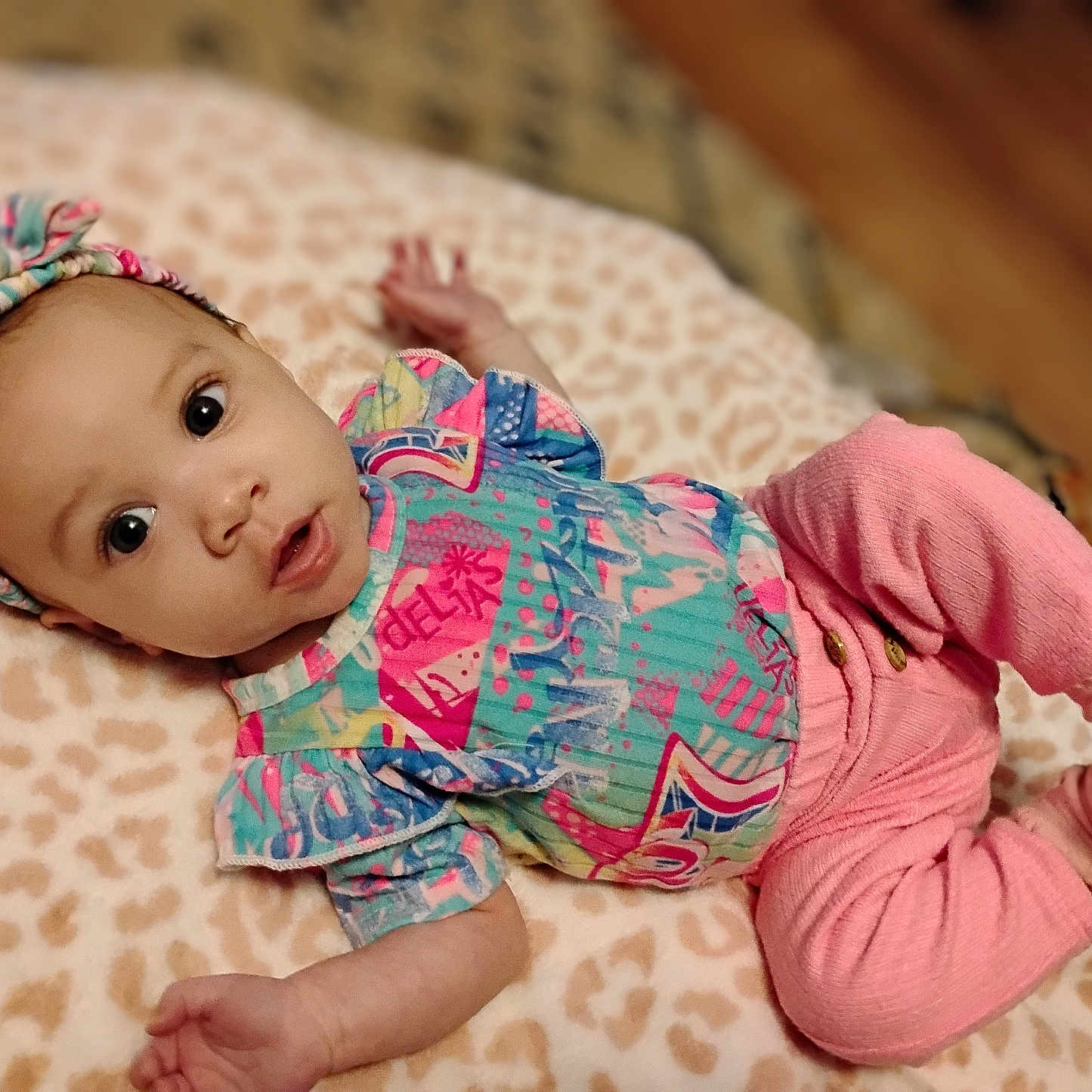 Calia is registered to the contest to win money with this photo: applique, baby, bodypart, bonnet, cap, clothing, face, finger, glove, hand, hardwood, hat, head, newborn, pants, pattern, person, photography, portrait, wood