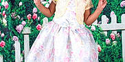 Journee joined the competition — help win amazing prizes! child, girl, smiling, posing, dress, floral, lace, bolero, peace_sign, braided_hair, beads, garden, flowers, greenery, white_picket_fence, grass, footwear, sandals, portrait, happy
