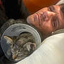 Harold is registered to the contest to win money with this photo: animal, bed, cat, closeup, comfort, cone, cuddle, face, friendship, human, indoor, kitten, man, pet, portrait, recovery, relaxation, resting, sleeping, soft_light