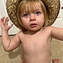 baby, blonde, bodypart, bonnet, cap, clothing, cowboyhat, face, finger, hair, hand, hat, head, person, photography, portrait, sitting, sombrero, sunhat, swimwear