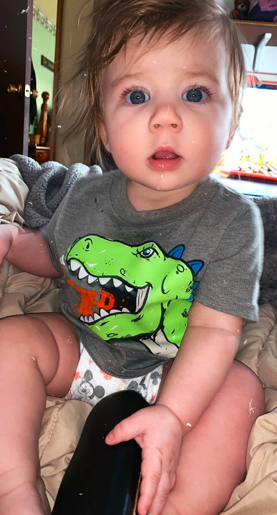 Jaxon is registered to the contest to win money with this photo: arm, baby, baby_toddler_clothing, black, cheek, child, clothing, eye, eyelash, finger, happy, iris, mouth, organ, person, sitting, skin, sleeve, snapshot, surprise