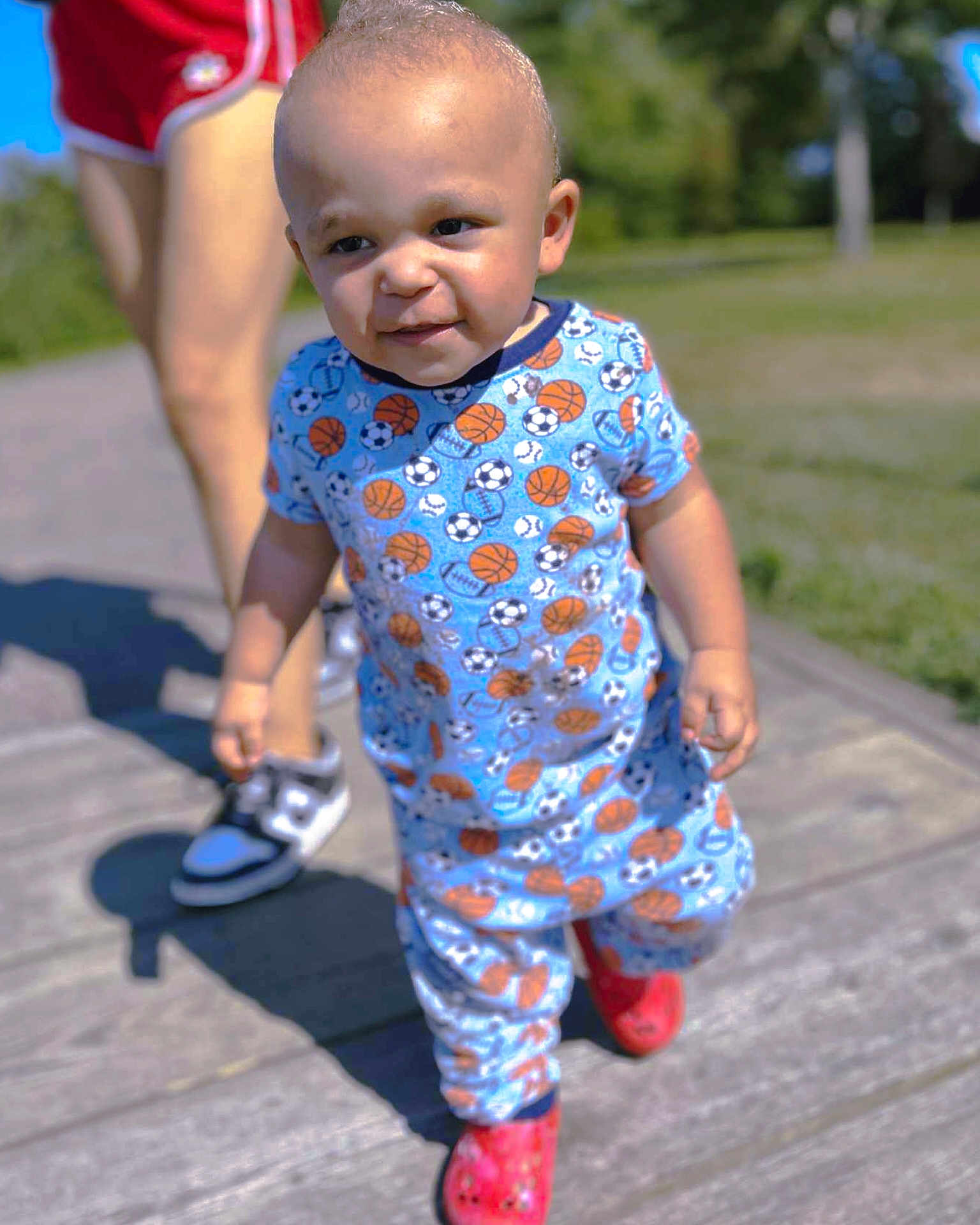 Jamal joined the competition — help win amazing prizes! toddler, child, outdoor, walking, sunny, sports_pattern, blue_outfit, red_shoes, person, legs, sneakers, sidewalk, nature, grass, daylight, cute, happy, baby, summer, portrait