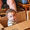 Jamal joined the competition — help win amazing prizes! toddler, child, cardboard_box, curly_hair, striped_shirt, indoor, furniture, wood, cushion, person, legs, phone, hands, expression, curious, puzzle, home, seated, casual, cozy