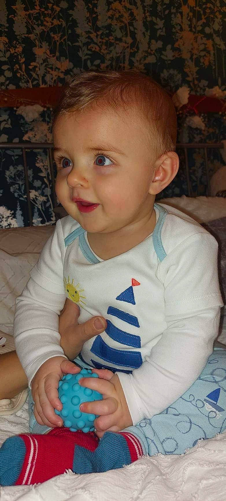 Caleb-james is registered to the contest to win money with this photo: arm, baby, baby_toddler_clothing, blue, cheek, child, chin, finger, fun, happy, human_body, iris, nose, organ, person, sitting, skin, sleeve, smile, thumb