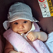 Hala joined the competition — help win amazing prizes! baby, infant, car_seat, hat, pink, white, strap, safety_belt, face, cute, child, seatbelt, car, warning_label, airbag, clothing, portrait, hand, skin, young